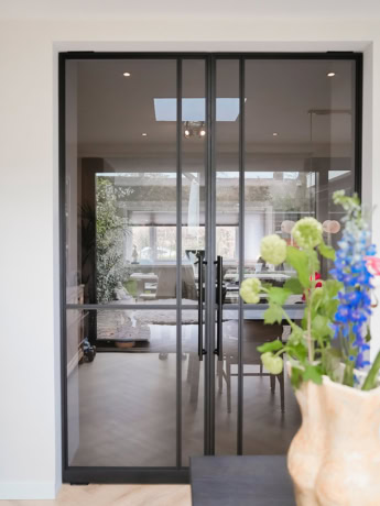 Black pivot door with clear glass