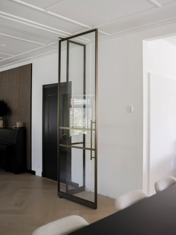 Clear glass pivot door in bronze